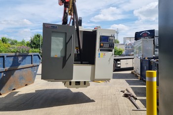 Machine being lowered to floor by crane